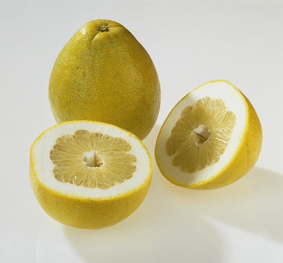 Whole and halved pomelo