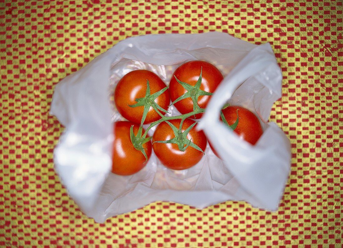 Truss of tomatoes in a plastic bag