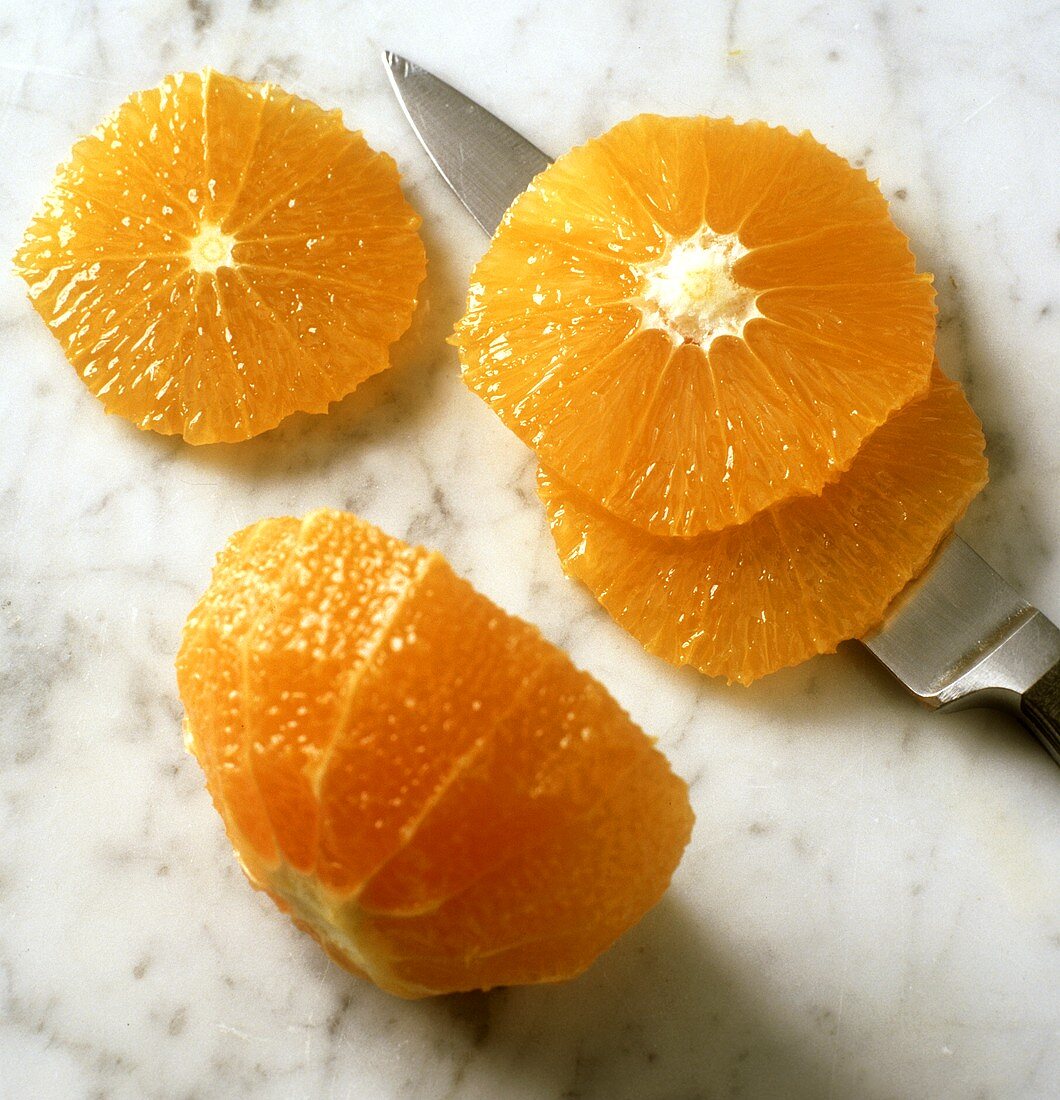 Slicing a peeled orange
