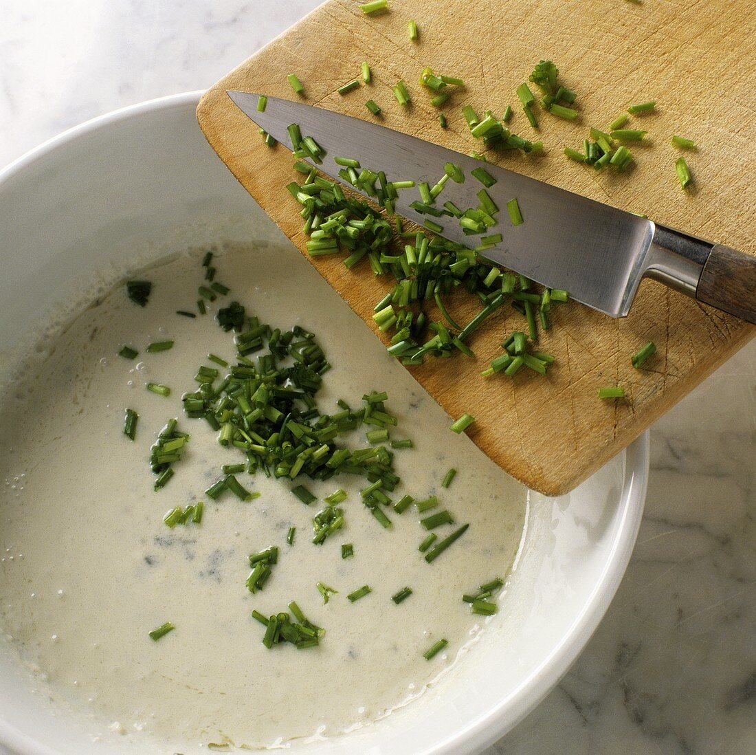 Making cheese sauce with chives
