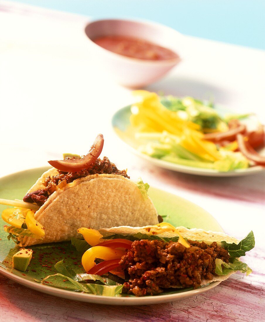 Tacos mit roter Chilisauce, Hackfleisch und Bohnenmus