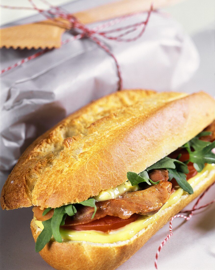 Baguette roll with cheese, ham and tomatoes