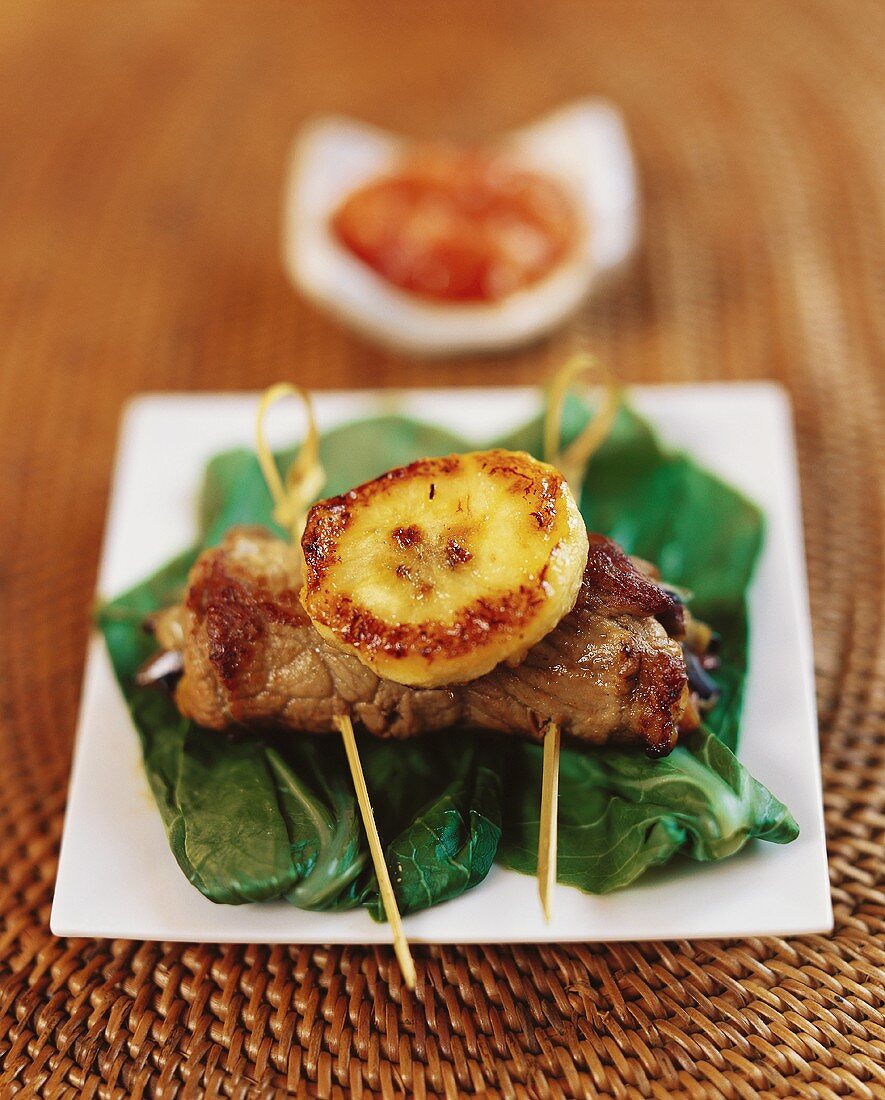 Beef roulade with grilled pineapple slice on pak choi