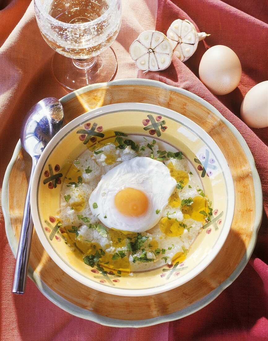 Portuguese bread soup with fried egg and garlic