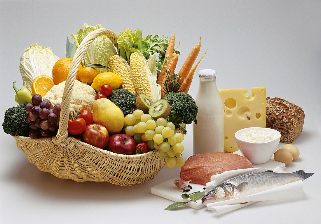 Basket of fruit and vegetables, fish, veal etc, beside it