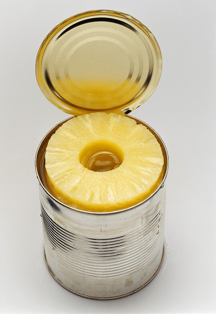 Pineapple slices in an opened tin