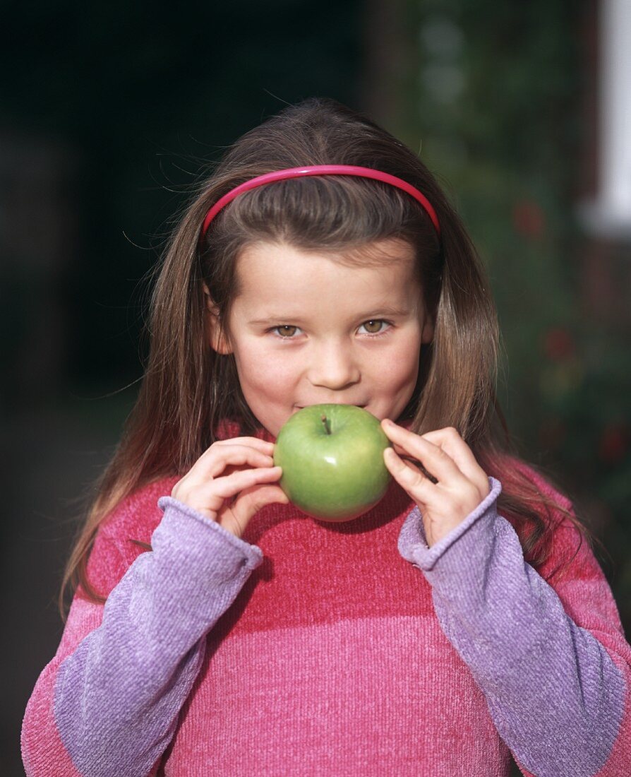 Girl with a Granny Smith apple