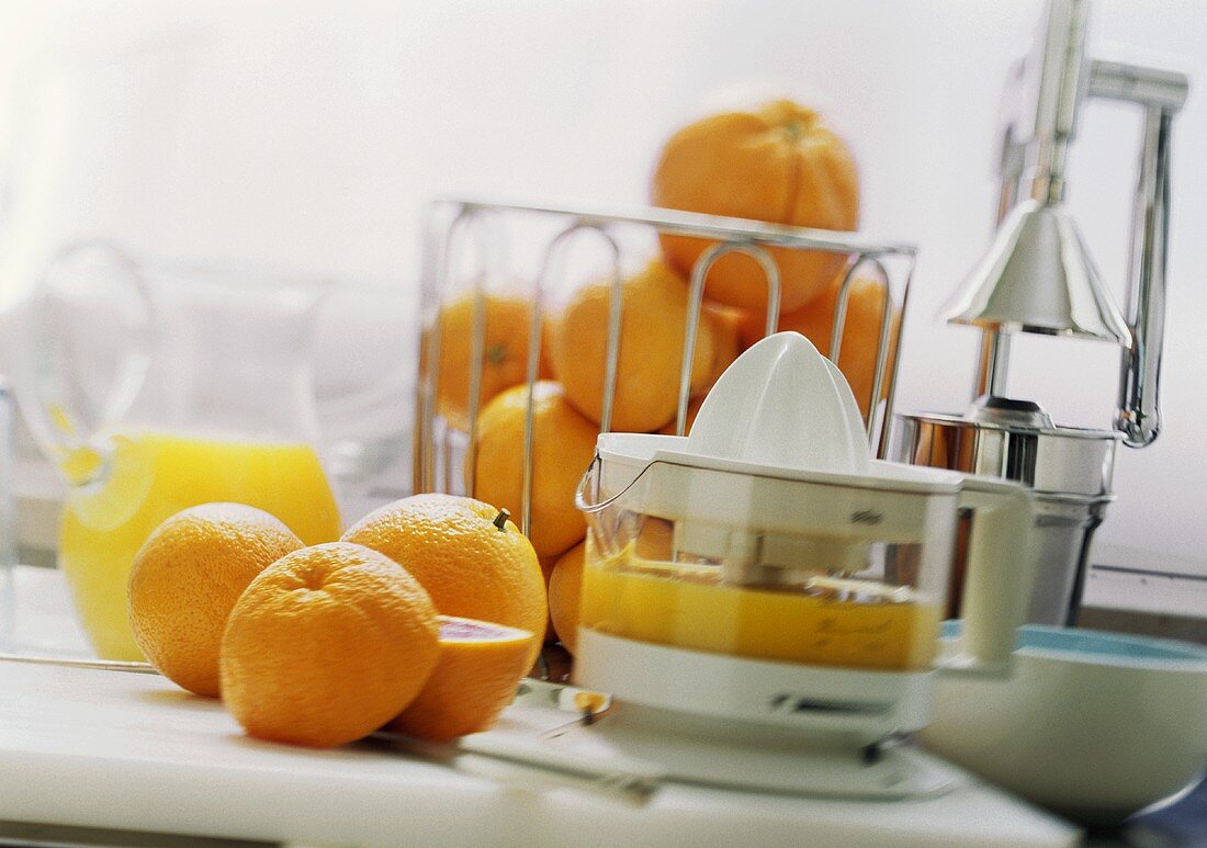 Still life with juicer, oranges and orange juice