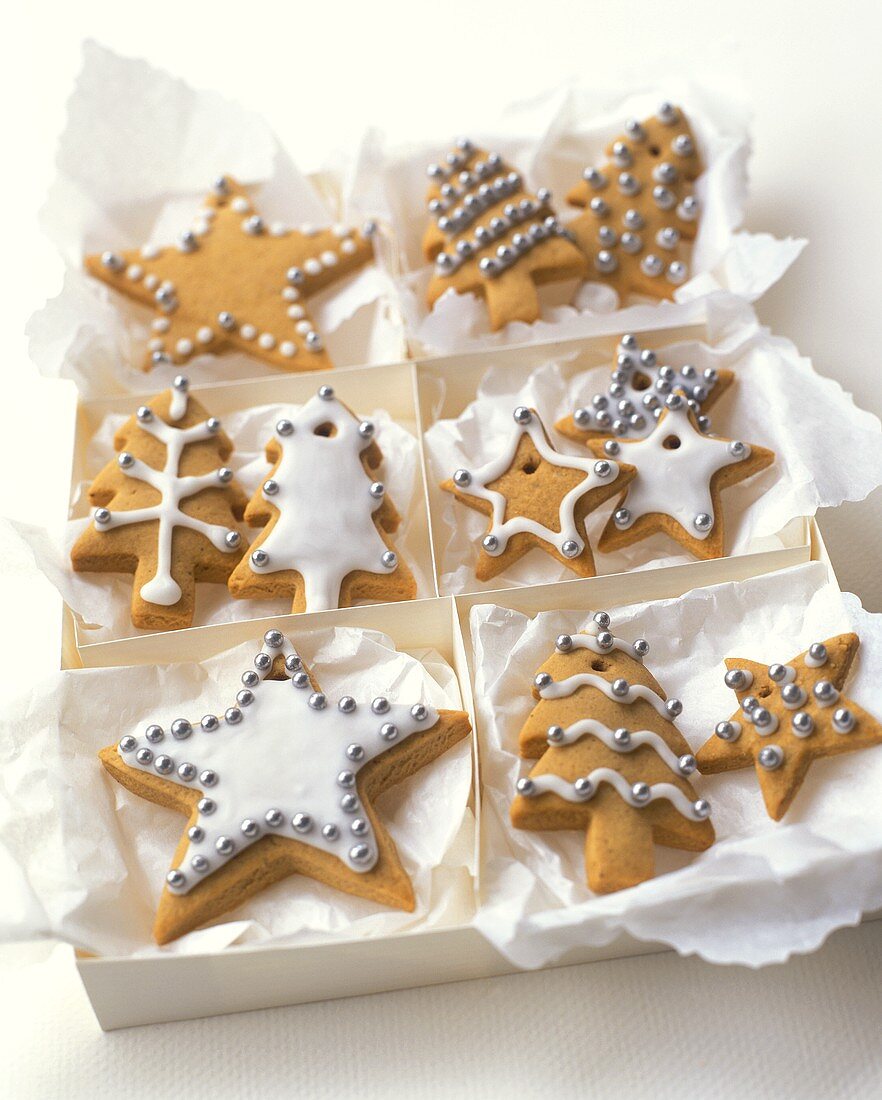 Glazed biscuits with silver balls as tree ornaments