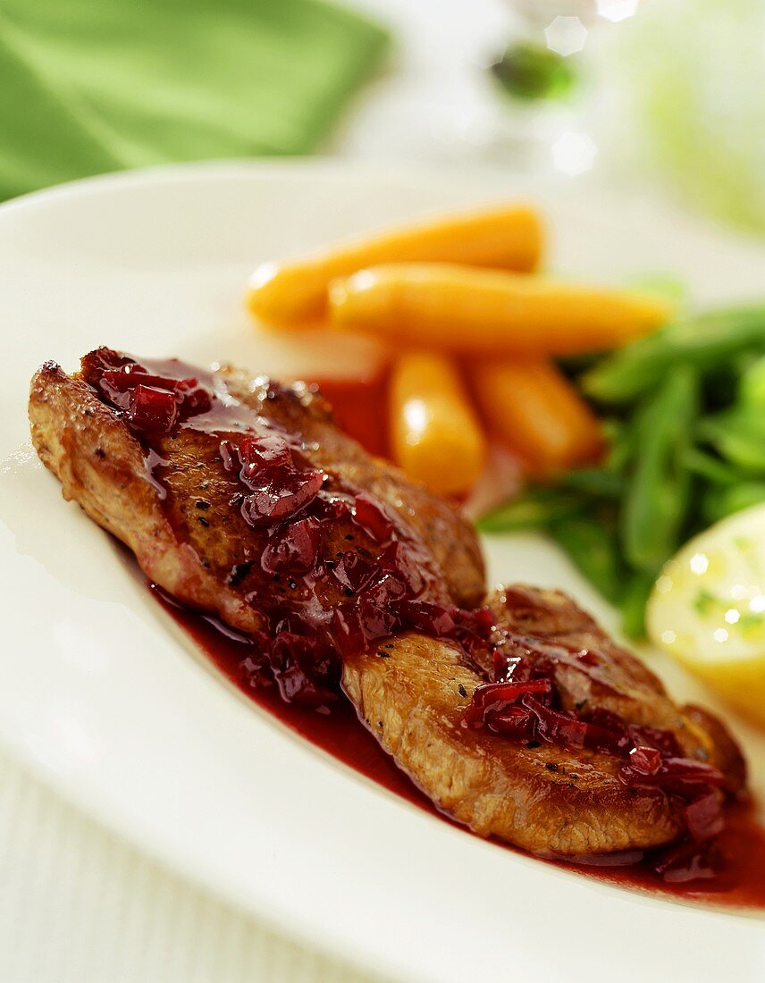 Pork escalope with beetroot sauce and vegetables