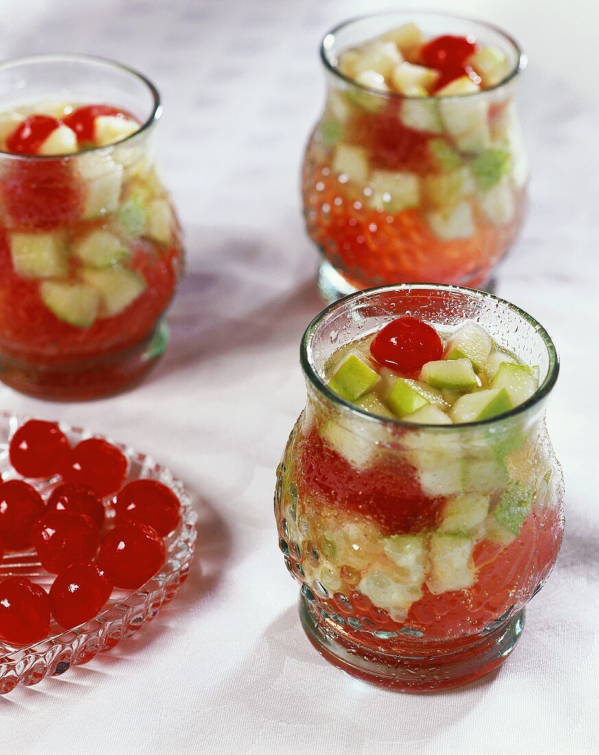 Punch with cocktail cherries in glasses