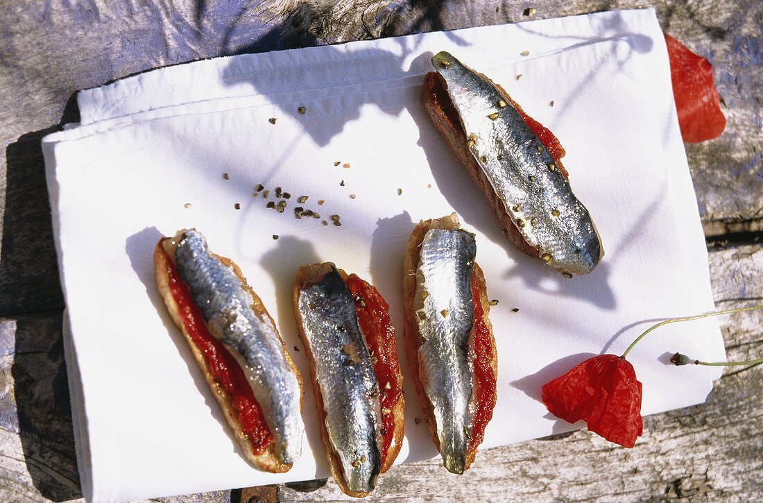 Crostini with sardines on white cloth