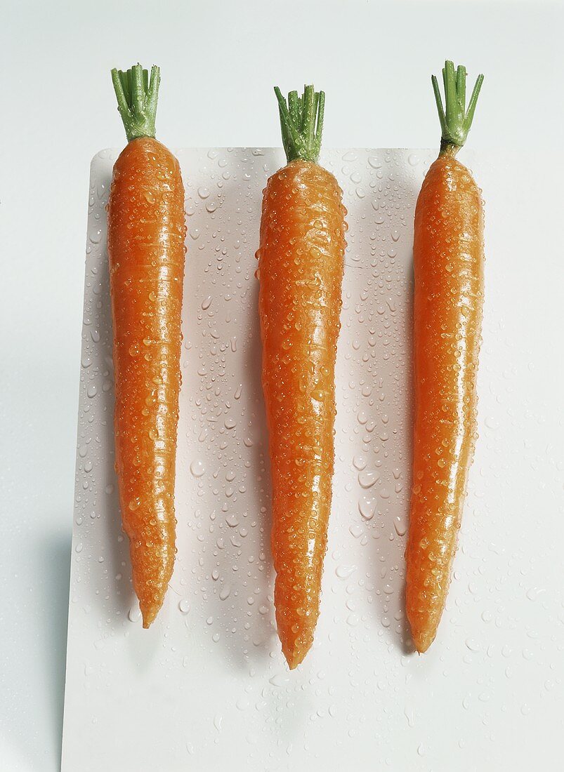 Three carrots with drops of water