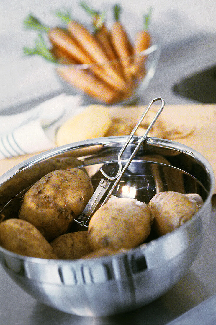 Potatoes in a metal bowl on the kitchen table
