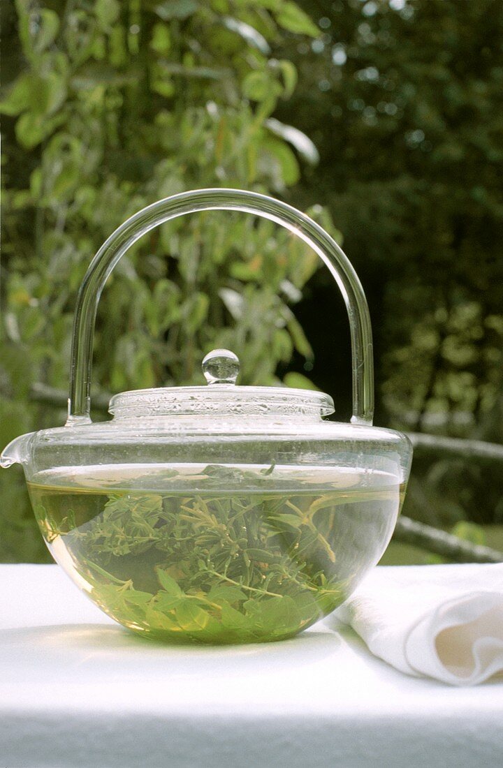 Herb tea in glass teapot