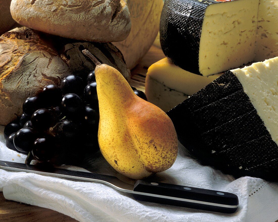 Still life with cheese, fruit and bread