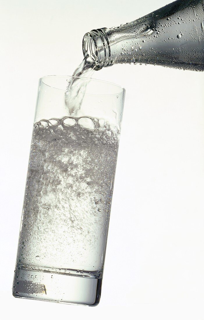 Pouring a glass of mineral water