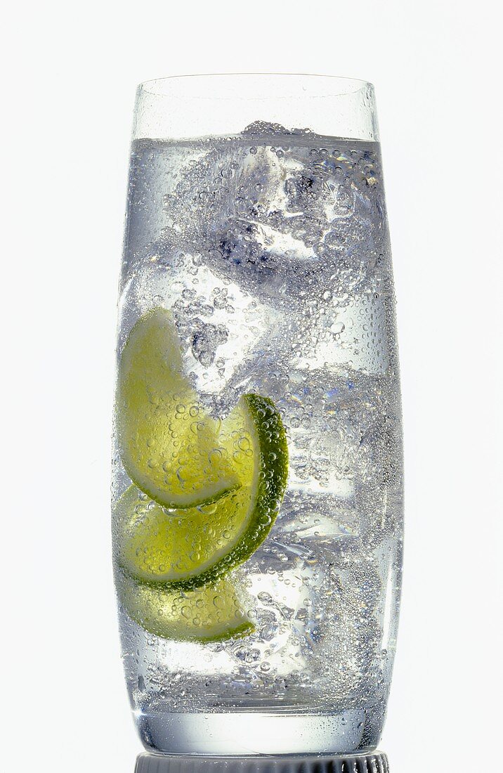 Glass of mineral water with ice cubes and lemon slices