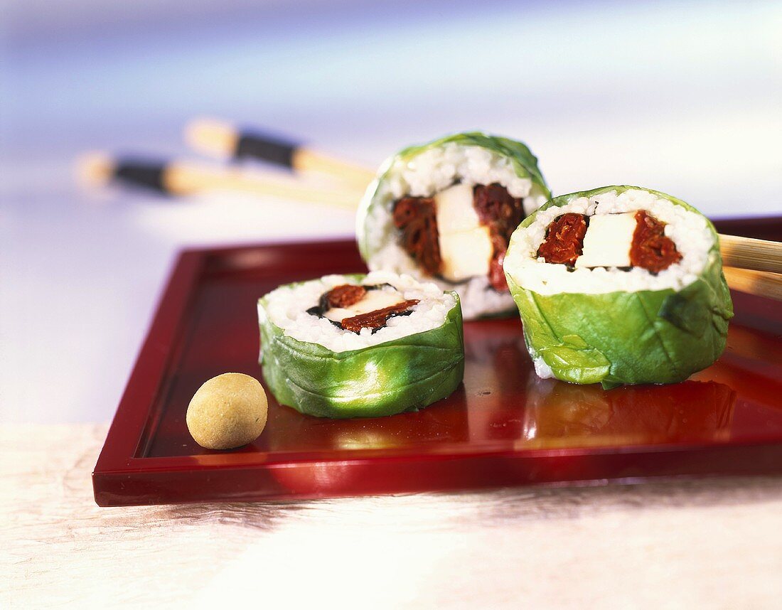 Sushi rolls with mozzarella and basil leaf