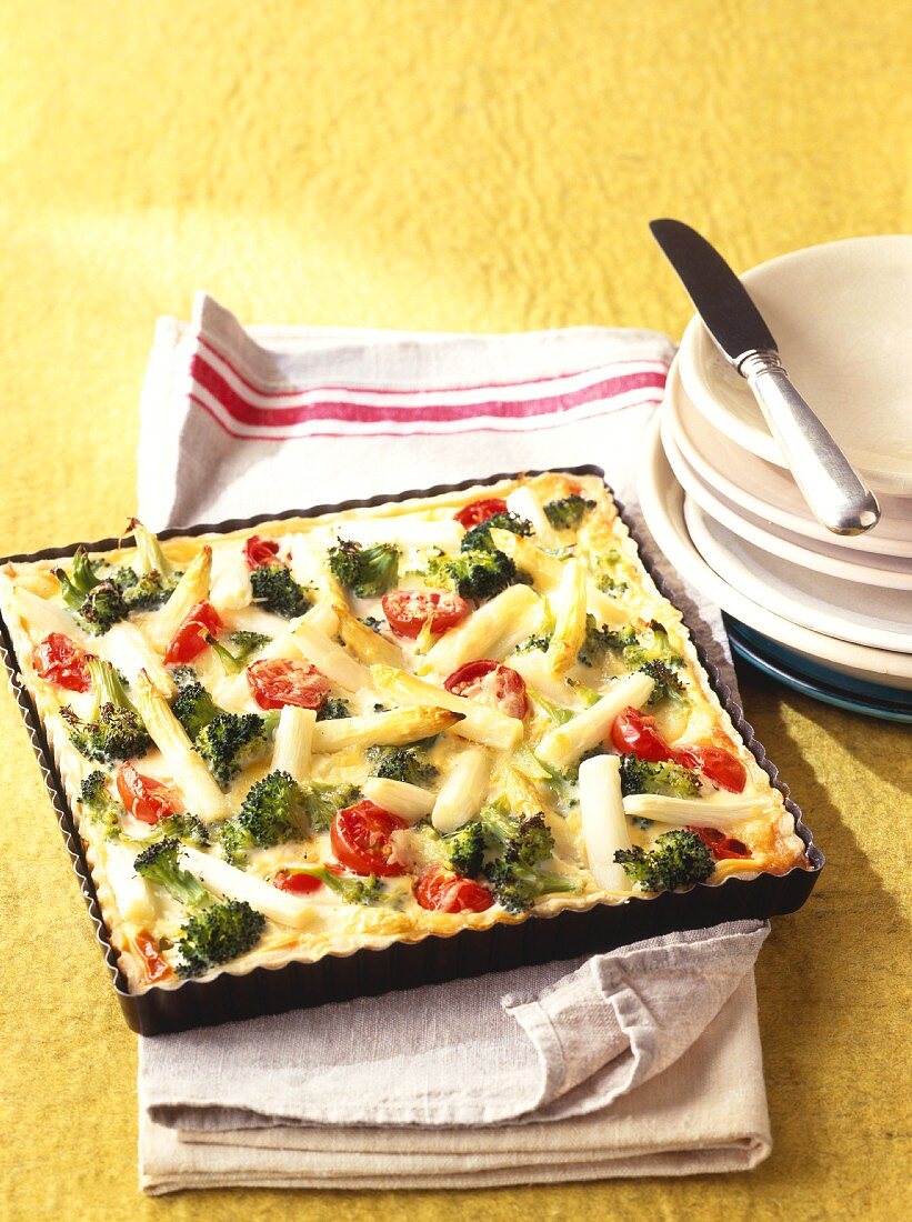 Asparagus quiche with broccoli & cherry tomatoes on baking tray