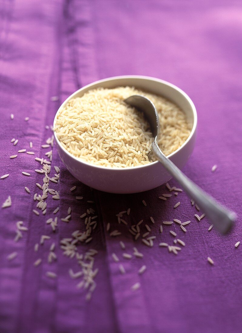 Bowl of Uncooked Rice with Spoon