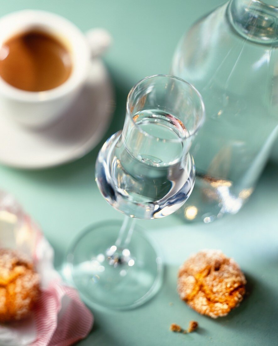 A glass of grappa and a cup of espresso