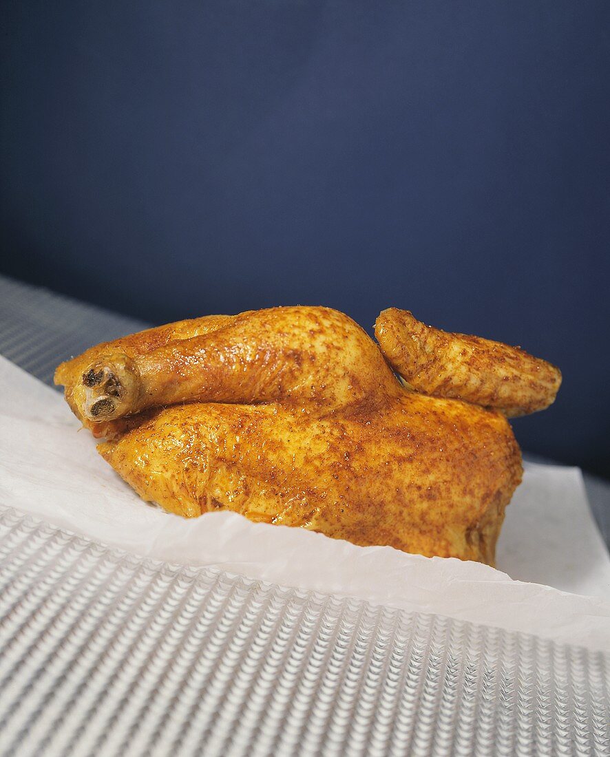 Half a roast chicken on baking paper