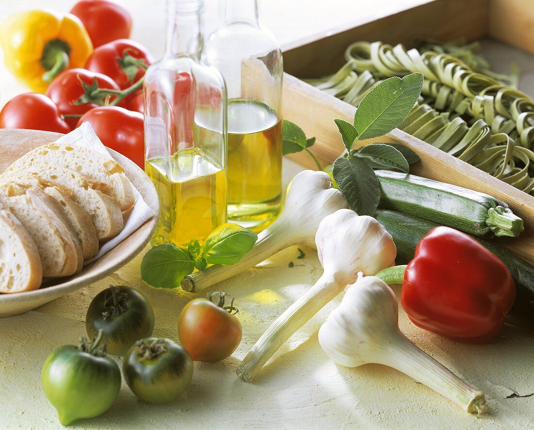 Still life: Mediterranean vegetables, bread, olive oil, pasta