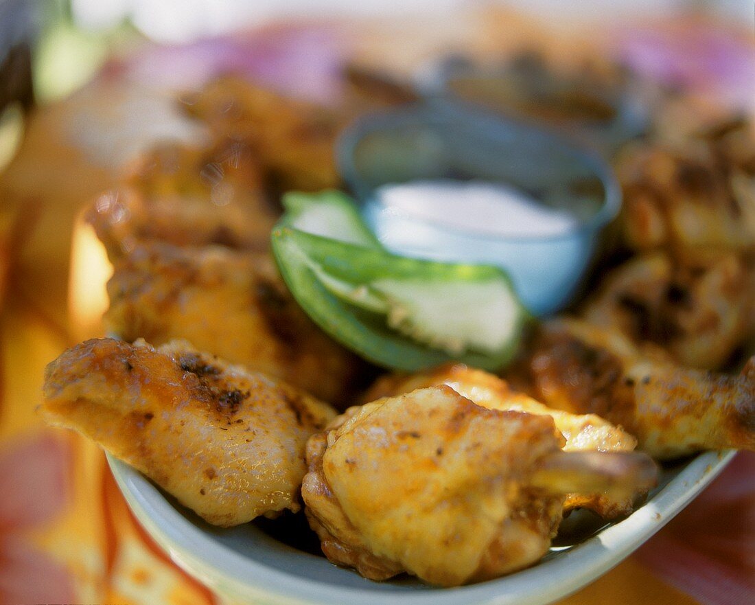 Chili chicken wings and a bowl of sour cream