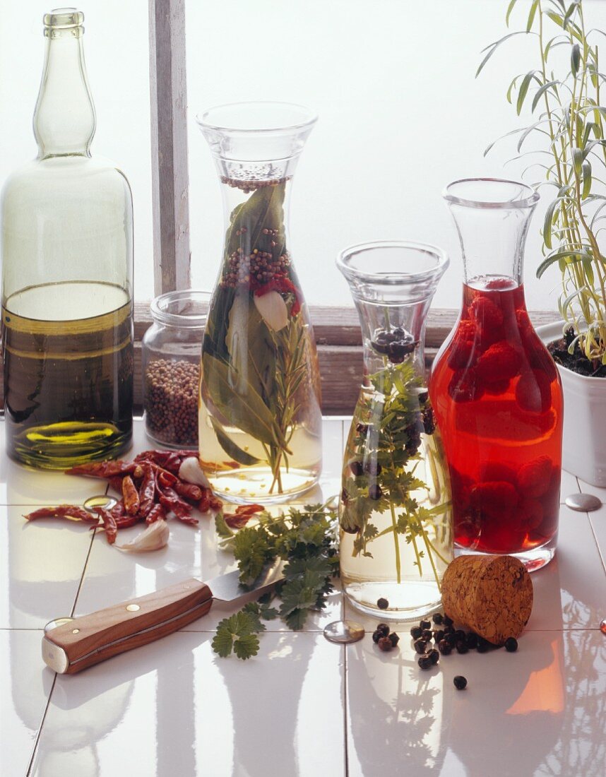 Still life with herb vinegars, raspberry vinegar & olive oil