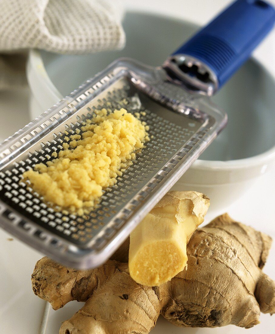 Ginger root and grated ginger on a grater
