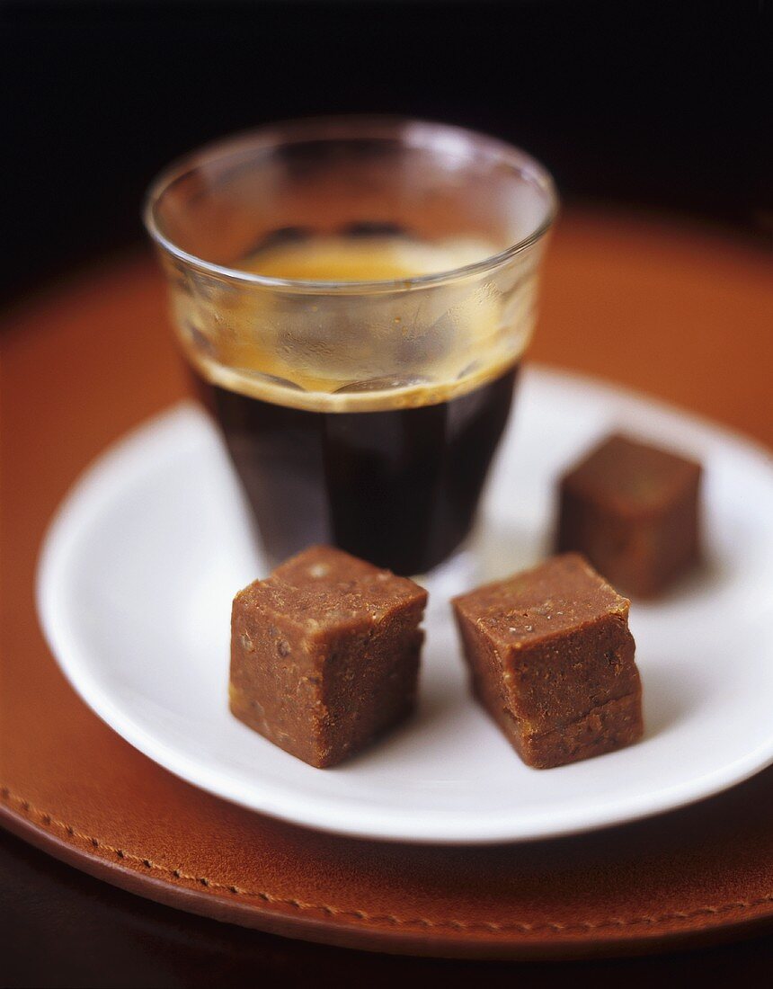 Hazelnut chocolate sweet and a glass of espresso