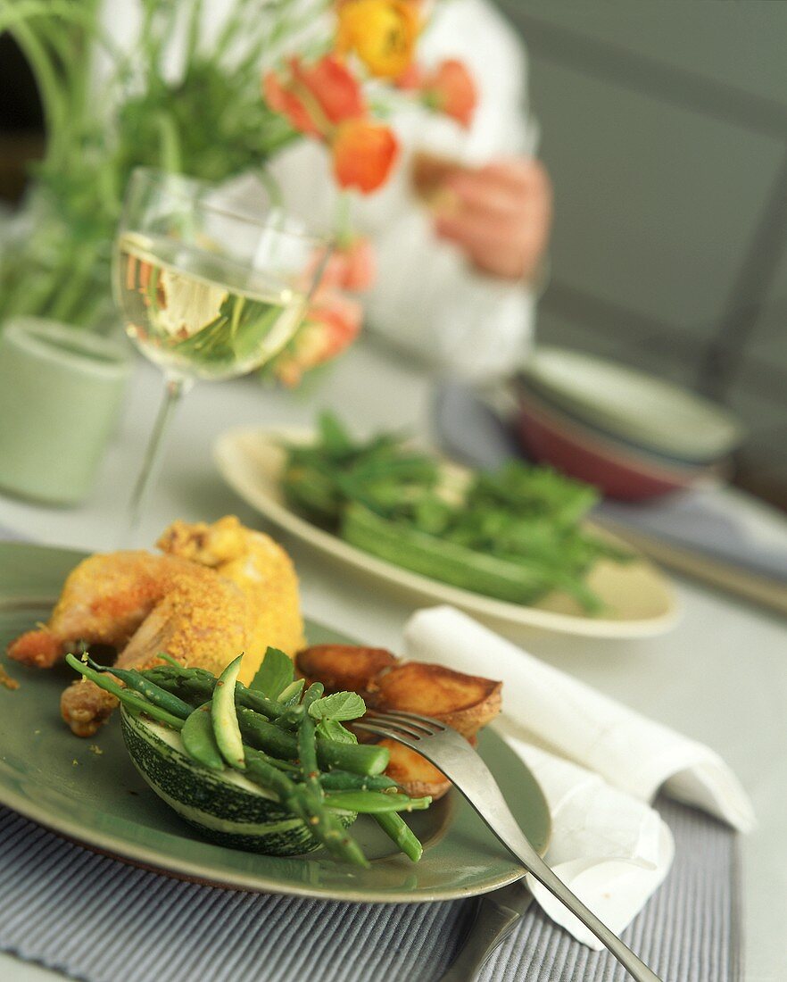 Fried chicken with spring vegetables, roast potatoes