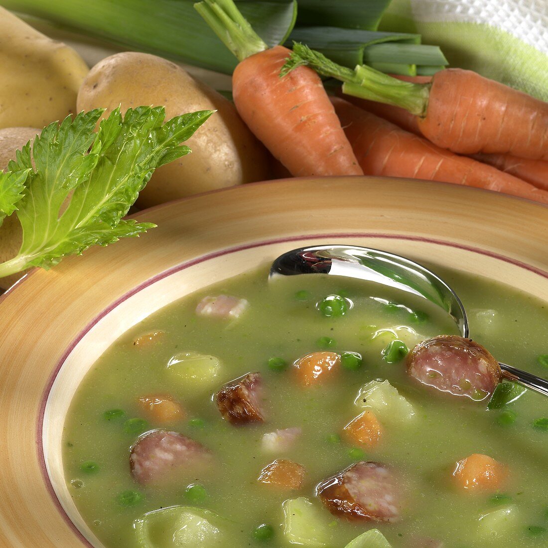 Pea soup with potatoes and sausage slices