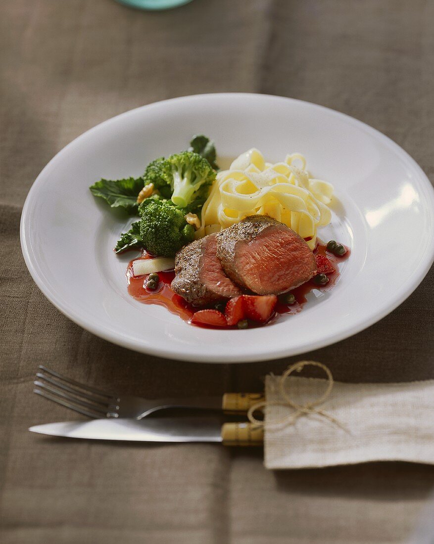 Venison medallions with strawberry and pepper sauce