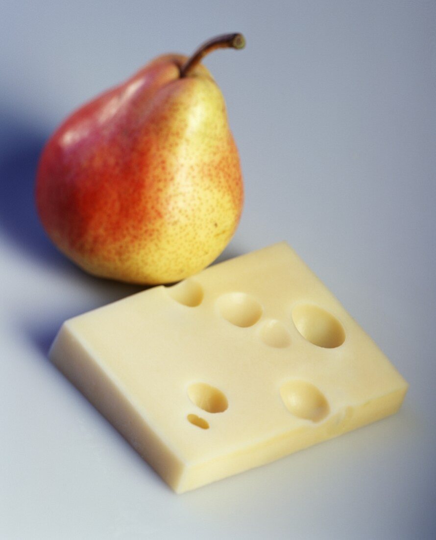 A piece of Emmental cheese and a pear