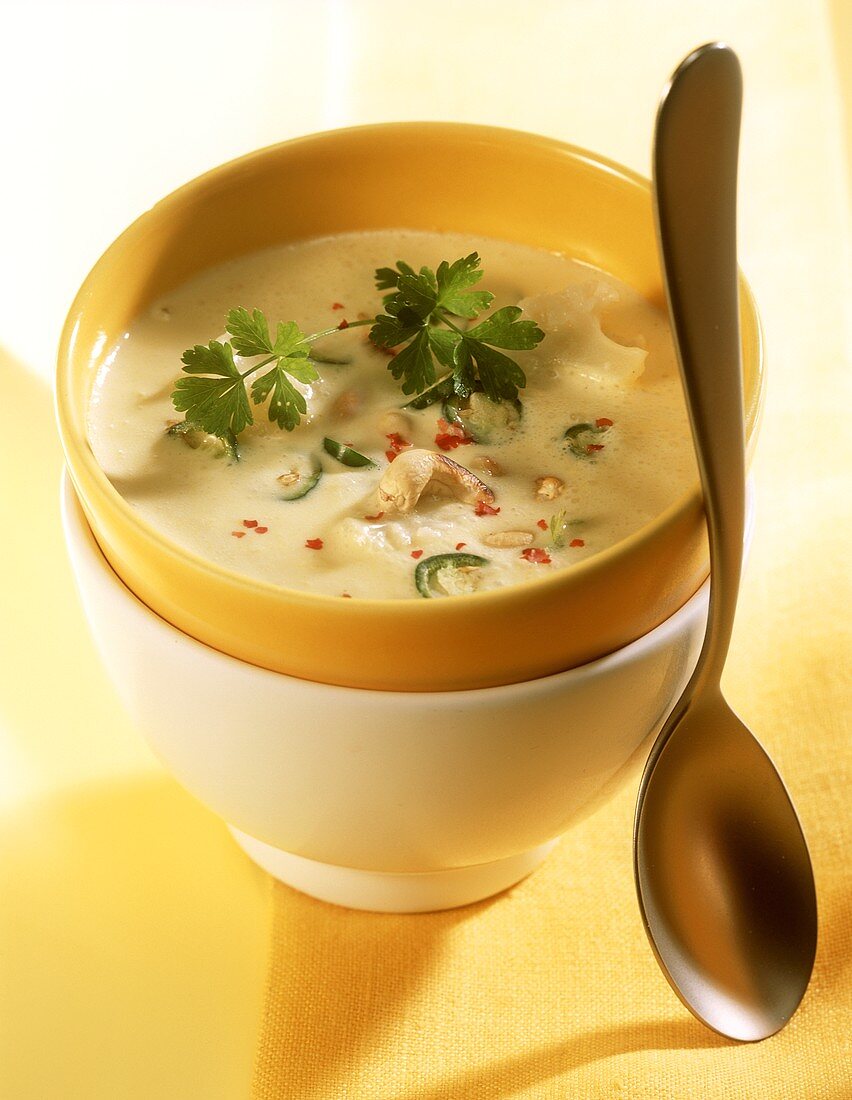 Creamy cauliflower soup with cashew nuts & chili rings