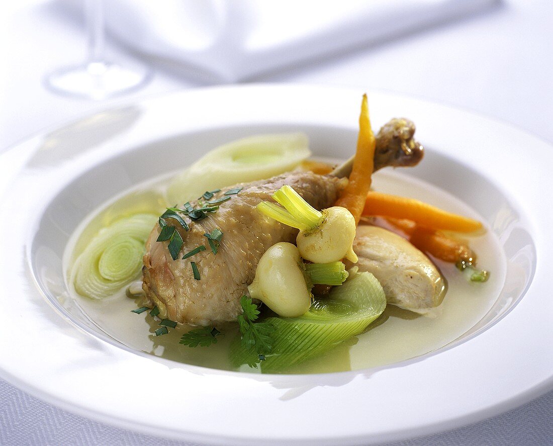 Boiled chicken with root vegetables and broth