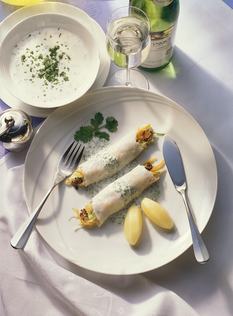 Steamed, stuffed fish rolls with chive sauce