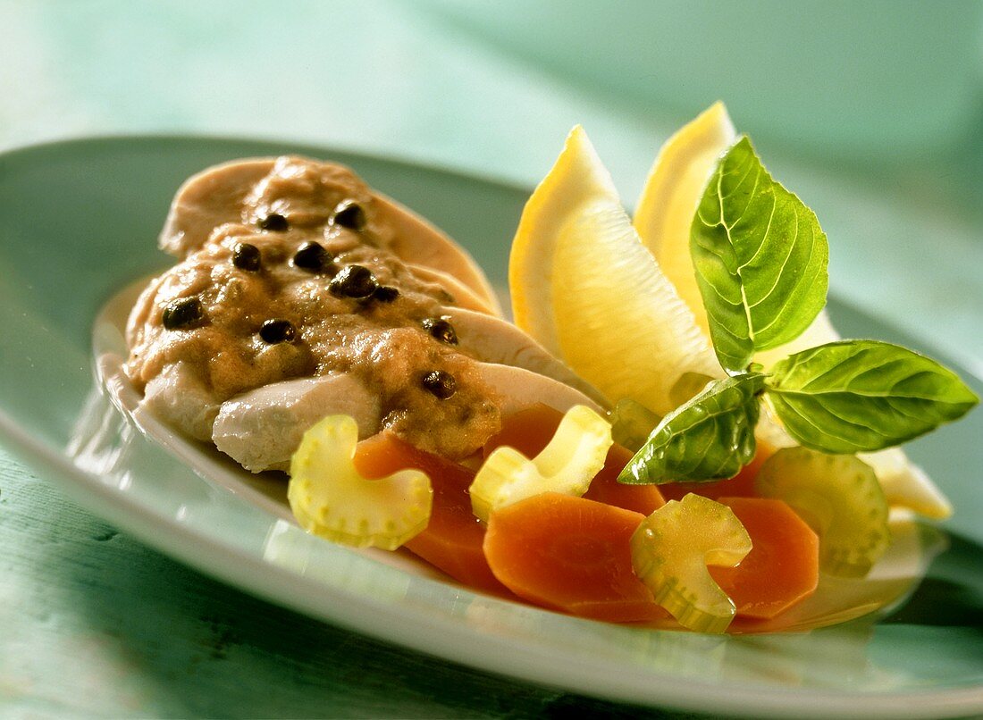 Chicken breast with tuna and caper sauce and vegetables
