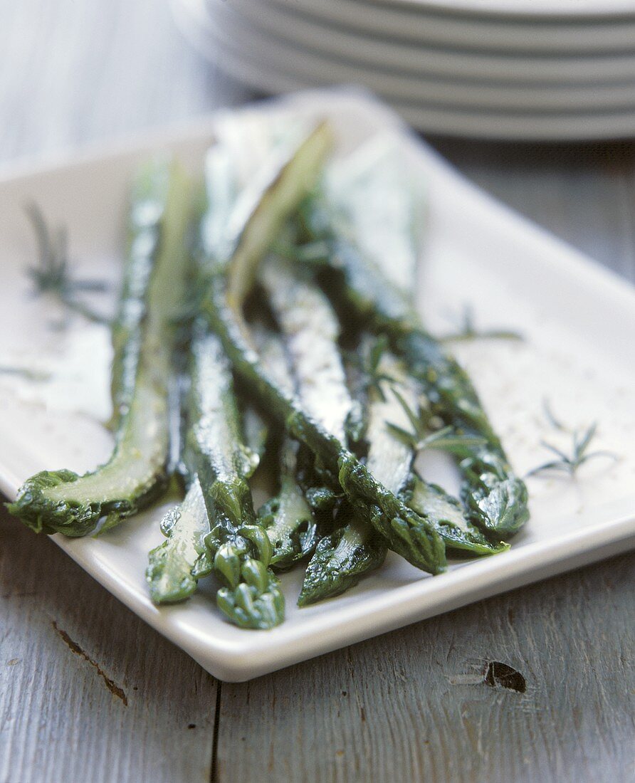 Blanched green asparagus with rosemary in mustard oil