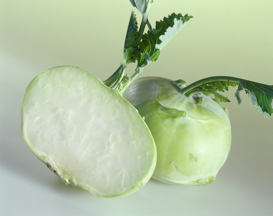 Half a kohlrabi in front of a whole one