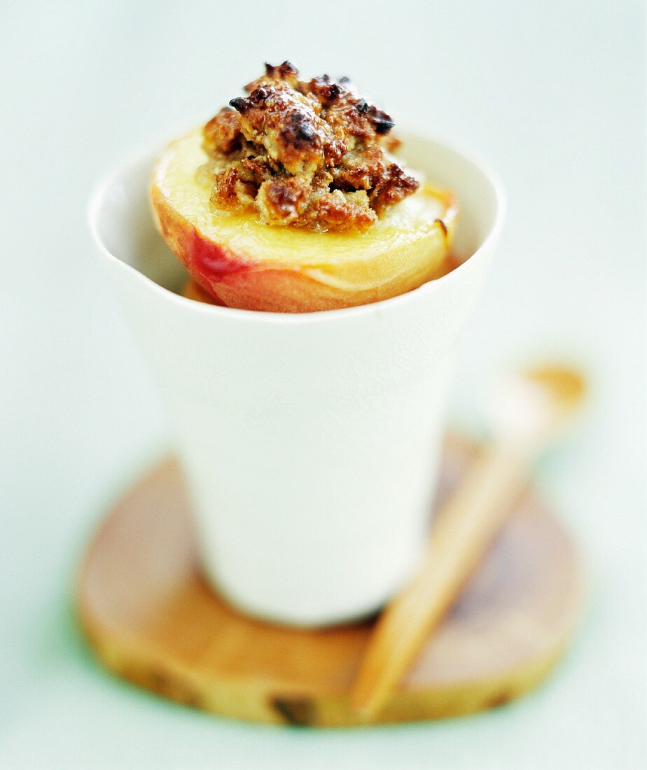 Baked peaches with amaretti stuffing in a beaker