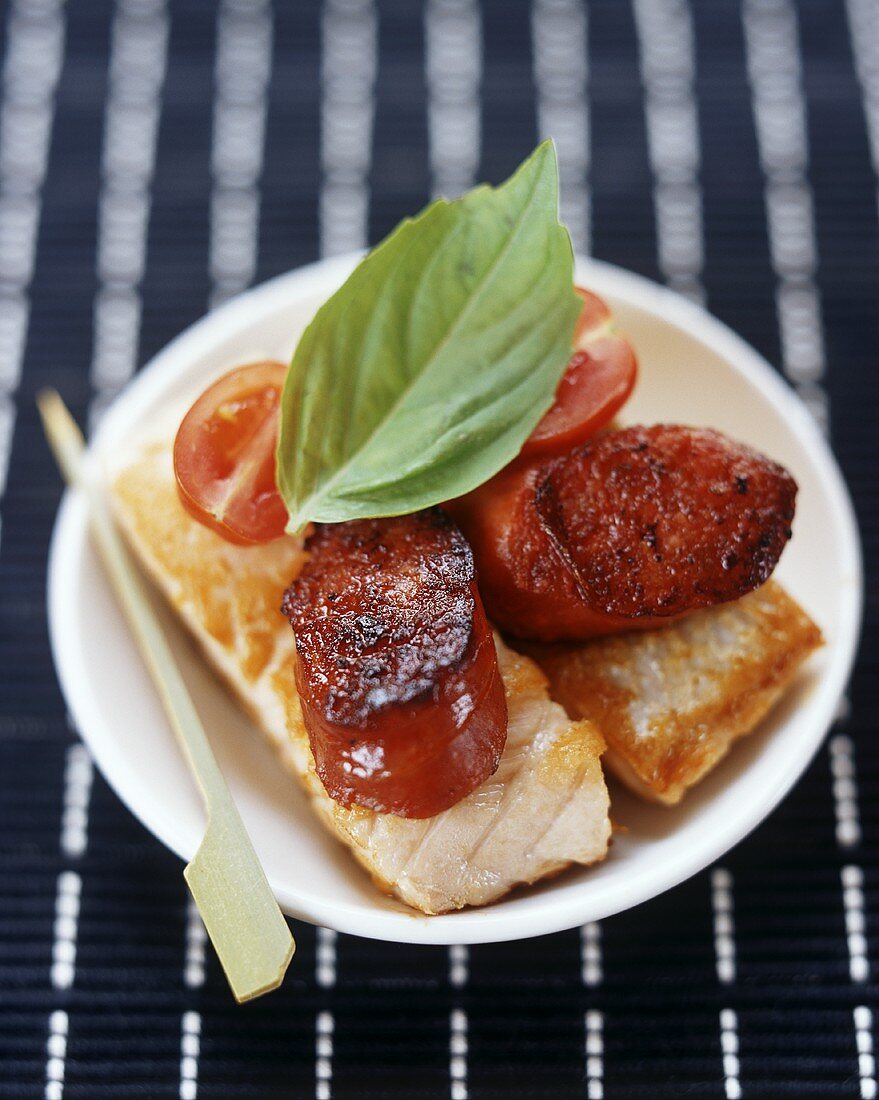 Salmon escalopes with chorizo, cherry tomatoes and basil