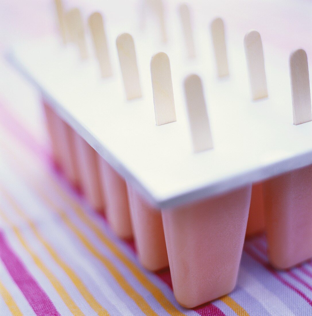 Several home-made strawberry ice creams with sticks
