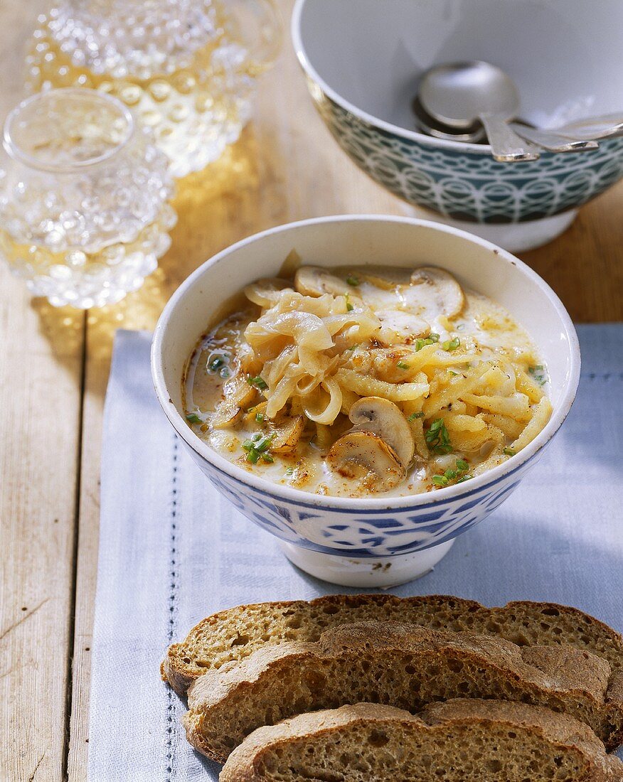 Cheese and noodle (spaetzle) soup with mushrooms