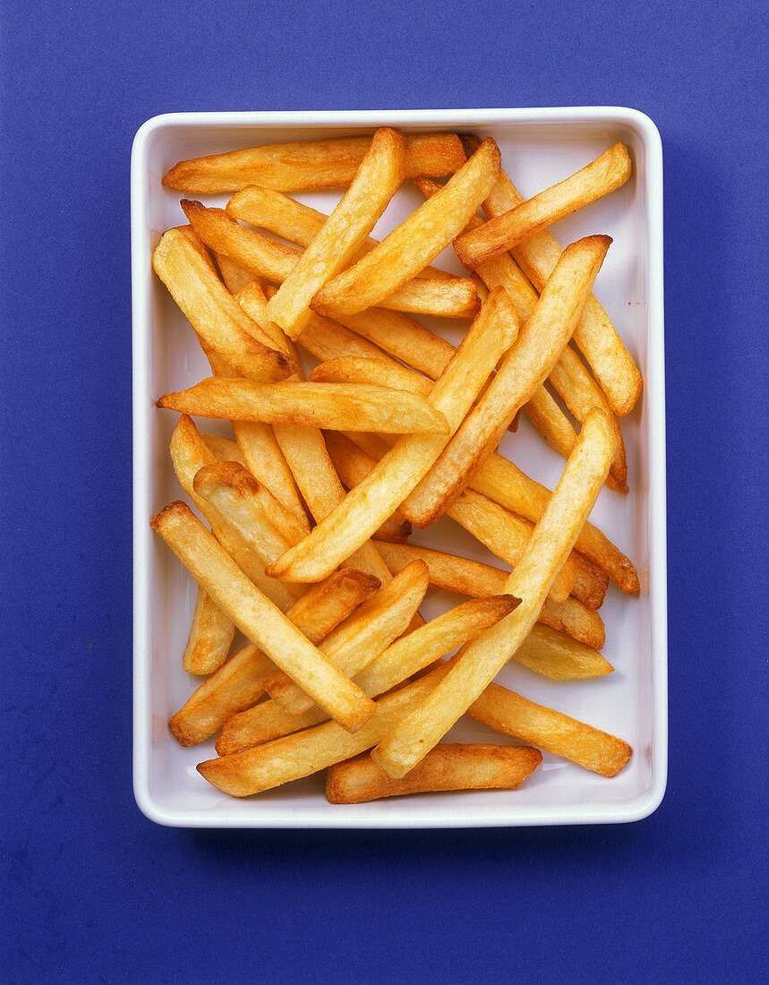 A bowl of chips on blue background