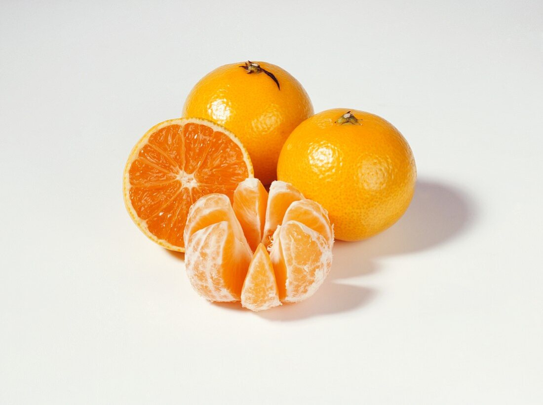 Clementines, two whole, one half and one peeled