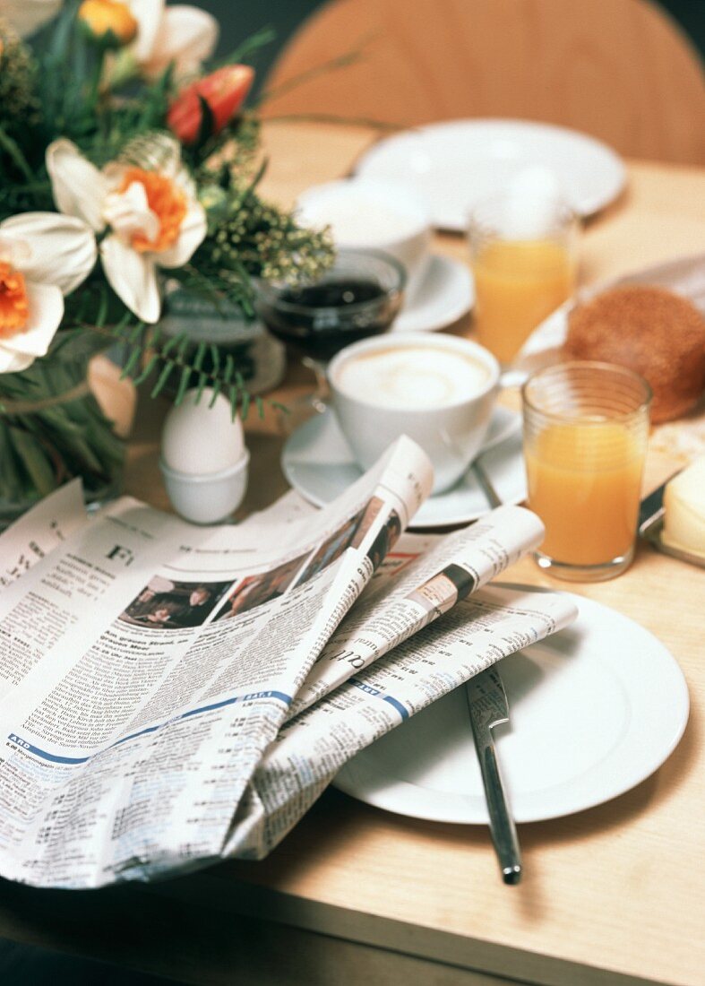 Breakfast table with newspaper