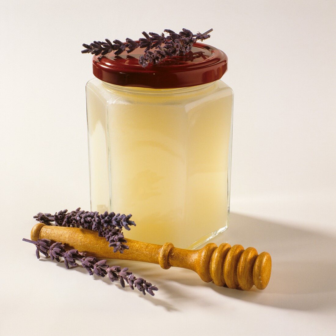 Lavender honey in glass, honey server in front